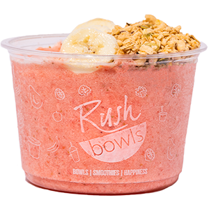 A pink Rush Bowls smoothie bowl with coconut, honey, and granola toppings. 