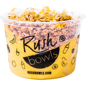 A yellow smoothie bowl with avocado, banana, and mango flavoring. 