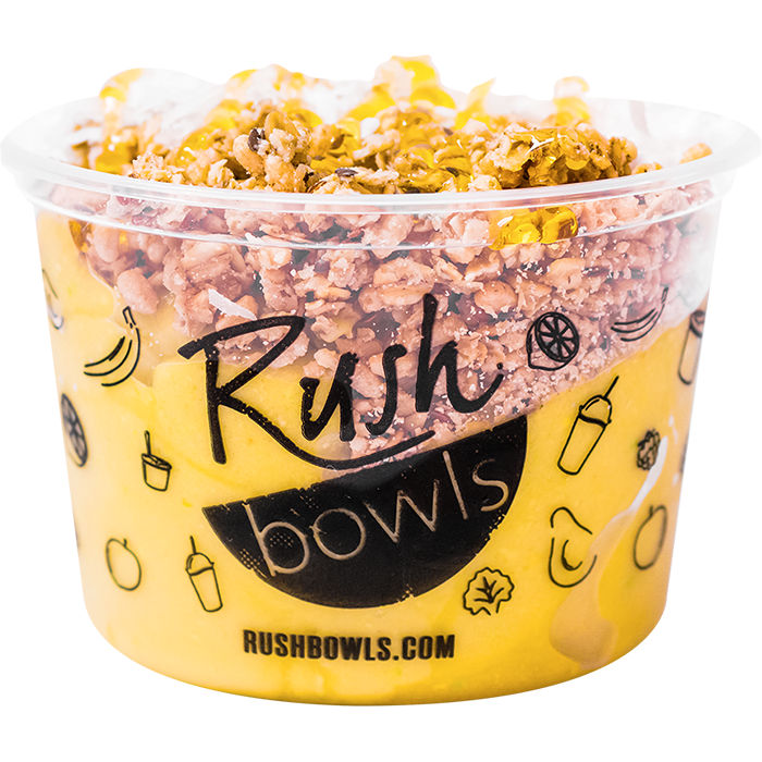 A yellow smoothie bowl with avocado, banana, and mango flavoring. 