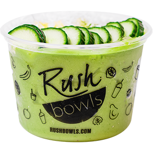 Green smoothie bowl with cucumber, avocado, kale, and peach flavoring with yummy toppings. 