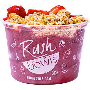 Rush Bowls smoothie pink acai bowl with strawberry and honey toppers.