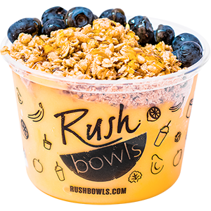 Yellow mango, pineapple, and guava flavored smoothie bowl with blueberry toppings. 