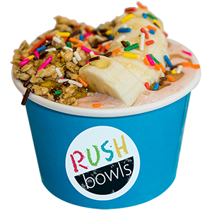 Kids smoothie bowl with sprinkles and peanut butter, strawberry, banana, flavoring. 